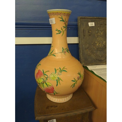 555 - A Chinese vase, bottle shaped with flared neck and decorated with nine peaches on an extensive peach... 