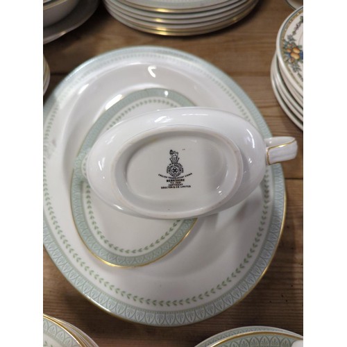 622 - Royal doulton dinner ware in green and gilded finish, serving dishes, tea cups and dinner/side plate... 