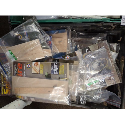 634 -  Two trays of build your own classic fighter plane, spitfire monthly RC Magazines with parts to... 