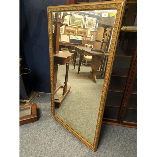 843 - Rectangular gilt framed mirror. 68cm wide x 125cm tall.