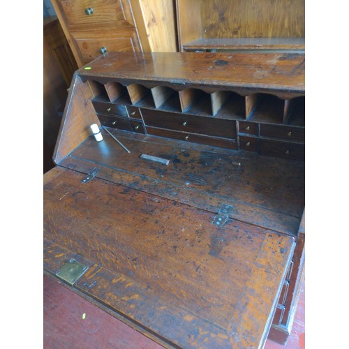 159 - Oak bureau with two over three drawers and internal stationary compartments, with key