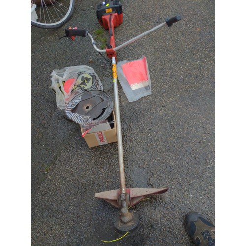 180 - Jonsered GR260 petrol strimmer with accessories and manual