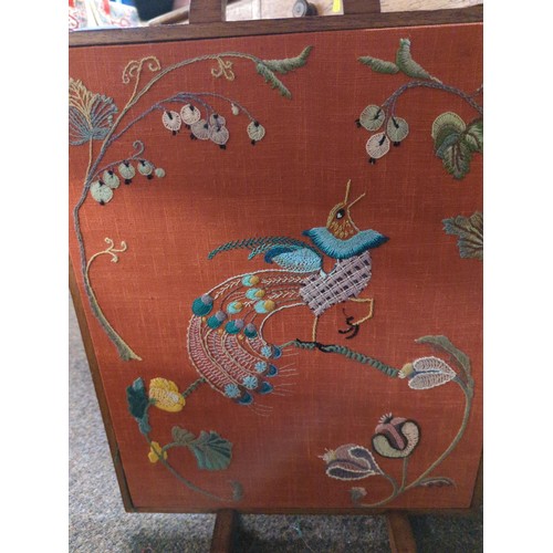 479 - Peacock embroidered oak fire screen. H63cm