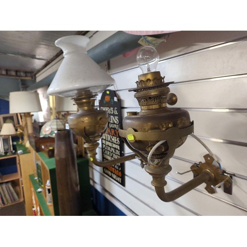 480 - Pair of wall mounted brass paraffin lamps converted to electric, one with missing shade & flue. ... 