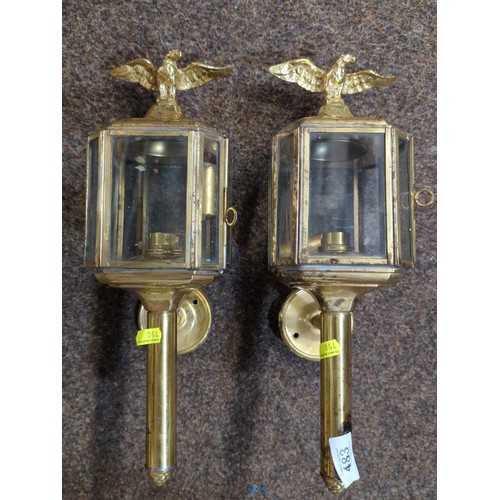 483 - Pair of brass eagle topped wall mounted electric lantern style lamps. H37cm