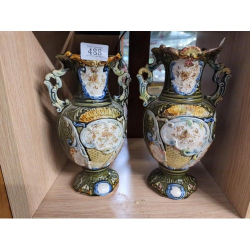 488 - Pair of early C20 ceramic twin handled vases in a green majolica style. H25cm