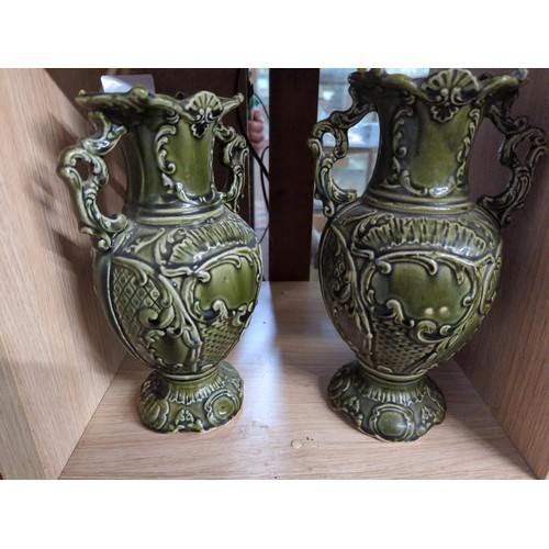 488 - Pair of early C20 ceramic twin handled vases in a green majolica style. H25cm