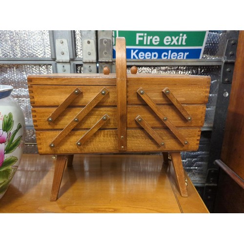 Wooden concertina sewing box on legs. W43 D25 H44cm