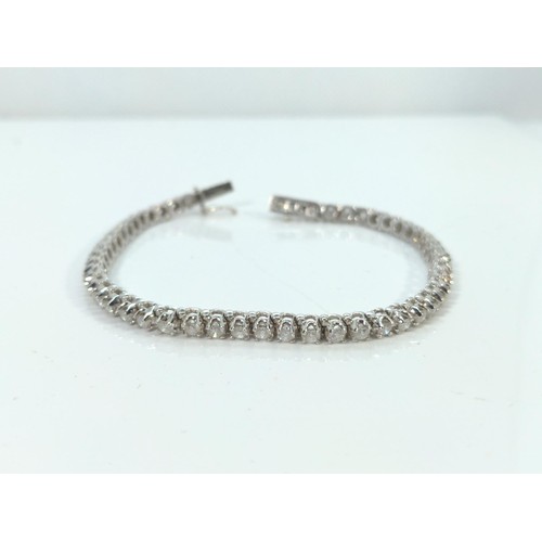 571 - 18ct white gold and diamond tennis bracelet, claw-set with 51 round brilliant-cut diamonds measuring... 