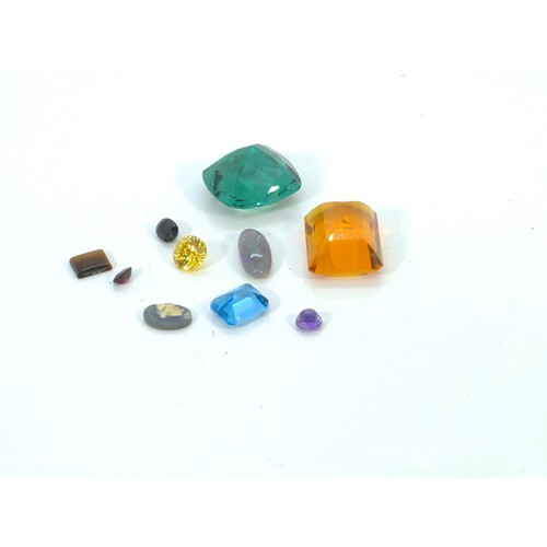 576 - Collection of loose gemstones, including citrine, opal, topaz, amethyst and others