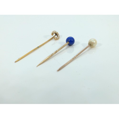 581 - Three yellow metal gem-set hat pins, tested positive for 9ct gold, gross weight 3.4 grams, one seed ... 