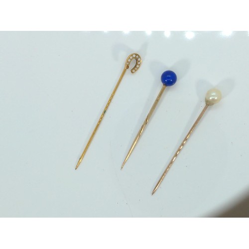 581 - Three yellow metal gem-set hat pins, tested positive for 9ct gold, gross weight 3.4 grams, one seed ... 