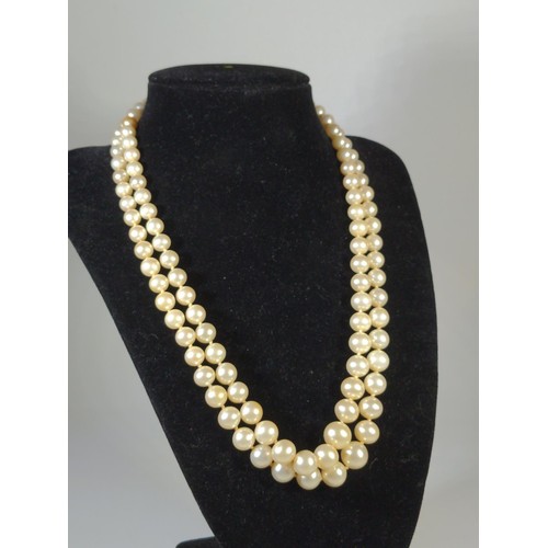 582 - Double strand simulated pearl necklace with a 9ct gold clasp