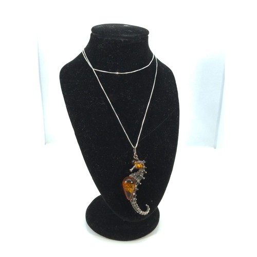 587 - Silver and amber seahorse pendant and chain, gross weight 7 grams