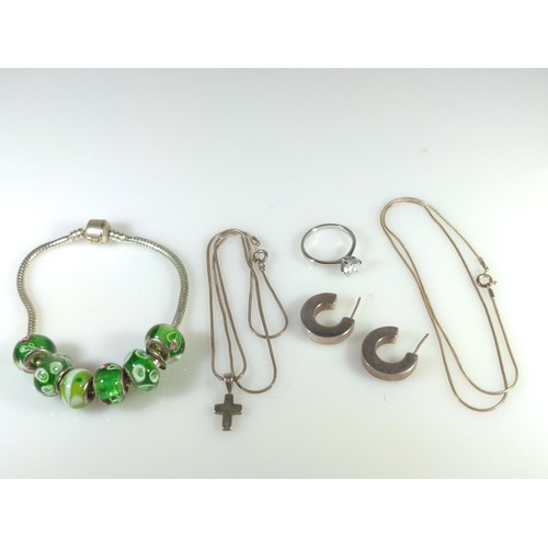 590 - Silver jewellery, including charm bracelet with glass beads, ring, pendant, two chains and a pair of... 