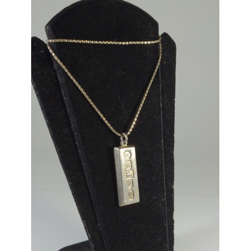 602 - Silver ingot pendant and chain, gross weight 34 grams