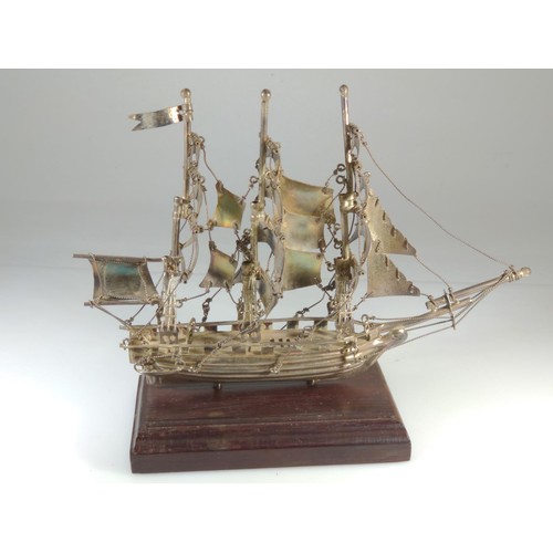 614 - Silver model ship on wooden plinth, marked 'Mexico 925', overall height 14cm, silver weight 96 grams