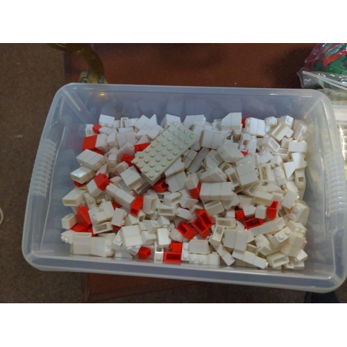 697A - 2 small bags & a small tub of plastic building pieces, inc windows & roofs