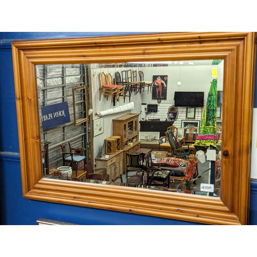 410A - Pine framed bevelled mirror, 81cm wide, 58cm high