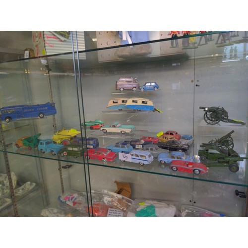 123 - Assorted play worn Dinky & Corgi cars & others plus a number of die cast military carriages ... 