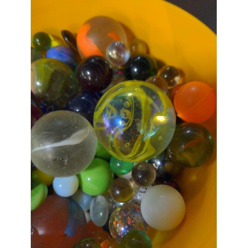 248 - Small orange tub of marbles, glass pebbles etc.