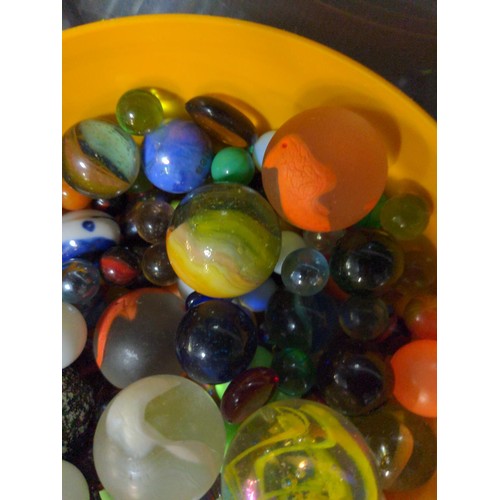 248 - Small orange tub of marbles, glass pebbles etc.