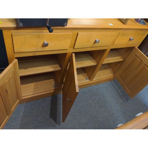 327 - Three drawer and three cupboard modern oak sideboard. W142 D46 H87 cm