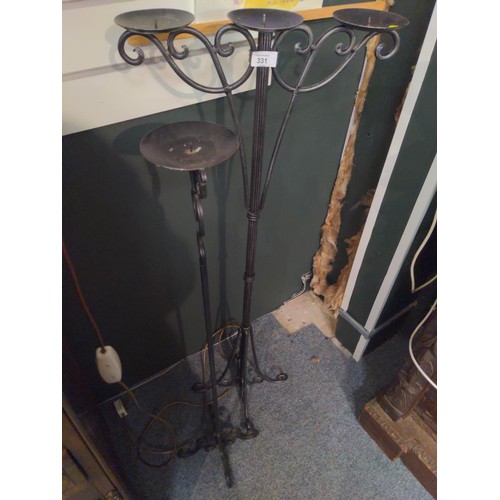 331 - Two floor standing wrought iron candle sticks. H120cm