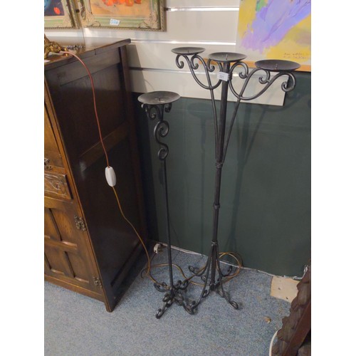 331 - Two floor standing wrought iron candle sticks. H120cm