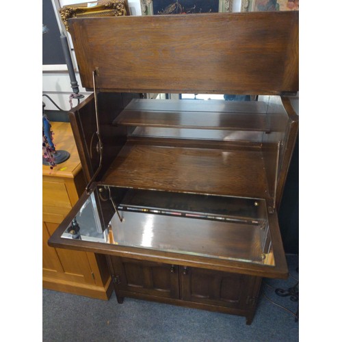 332 - Oak carved cocktail cabinet with pull down front door and one drawer and two cupboard doors. W77 D46... 