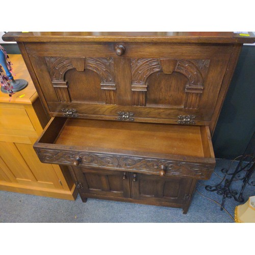 332 - Oak carved cocktail cabinet with pull down front door and one drawer and two cupboard doors. W77 D46... 