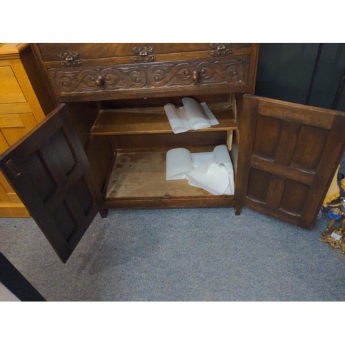 332 - Oak carved cocktail cabinet with pull down front door and one drawer and two cupboard doors. W77 D46... 