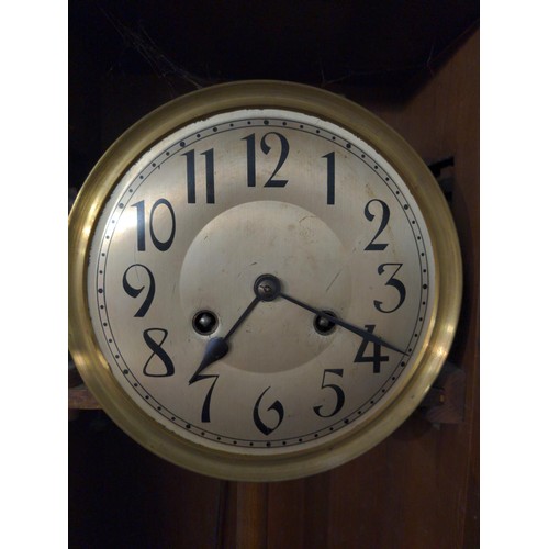 354 - Mahogany cased wall clock with brass face and brass pendulum and features a stained glass viewing pa... 