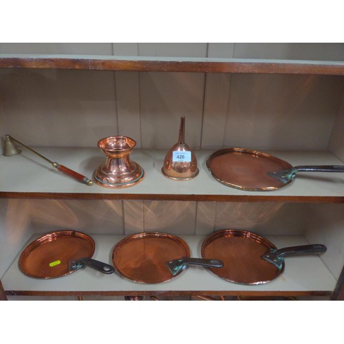 426 - 3 shelves of copper ware inc. copper lids largest 21cm. 2 funnels  other items. 