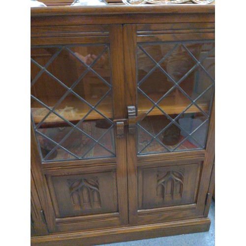 454 - Part glazed stained pine sideboard. Carving to doors in an ecclesiastical style. 140cm wide x 28.5cm... 