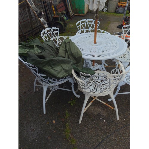 832 - White painted cast aluminium garden table and six chairs, with parasol