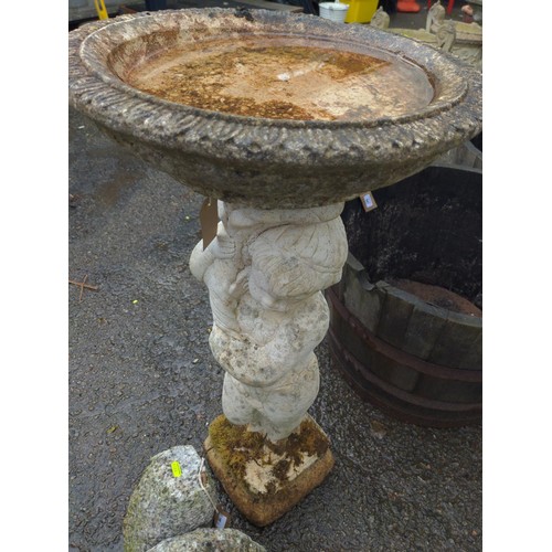 845 - Putto supported concrete bird bath, height 90cm