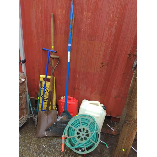 734 - Long handled tools, hose on reel, pump sprayer and other items