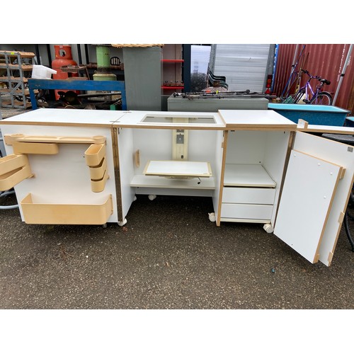 103 - Horn sewing machine cabinet and work station with foldout work space/cutting table and electric sewi... 