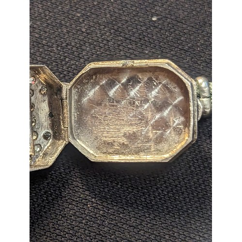 43 - Platinum cased Art Deco watch set with diamonds and green stones on a white metal strap (testing pos... 