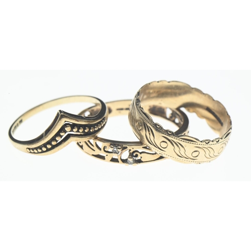 74 - Three 9ct gold rings; one openwork with four white stones, size R/S, together with a decorative band... 