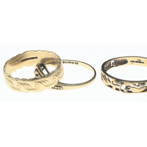 74 - Three 9ct gold rings; one openwork with four white stones, size R/S, together with a decorative band... 