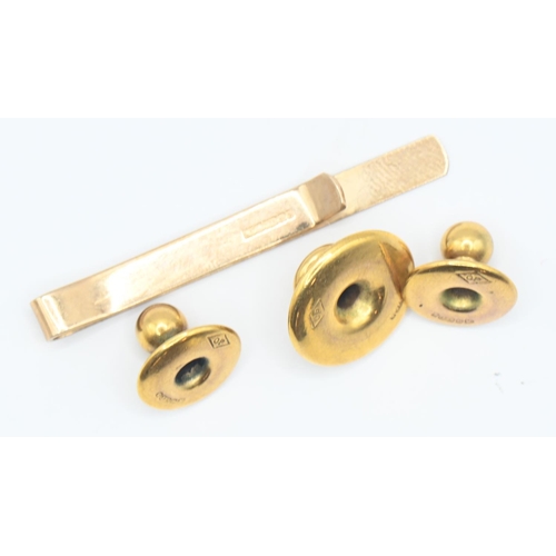 85 - Three 9ct gold buttons and a 9ct gold tie clip, gross weight 3.6 grams