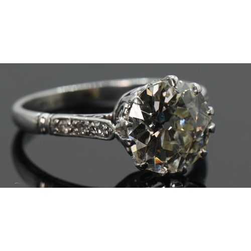 97 - Impressive diamond set ring on platinum. 2.58 carat (approx) central old European cut diamond. Scrol... 