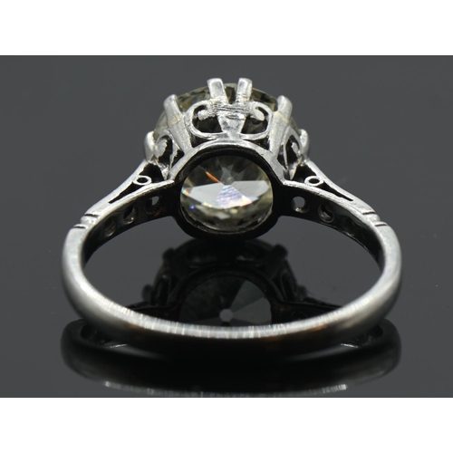 97 - Impressive diamond set ring on platinum. 2.58 carat (approx) central old European cut diamond. Scrol... 