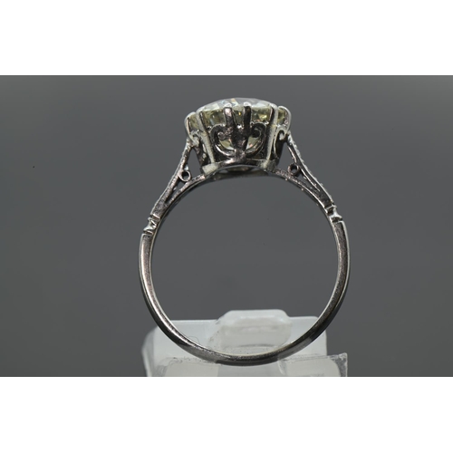 97 - Impressive diamond set ring on platinum. 2.58 carat (approx) central old European cut diamond. Scrol... 