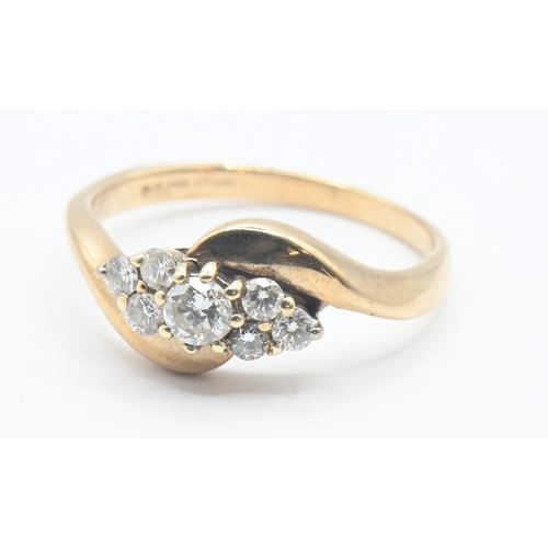 104 - 9ct gold and diamond crossover ring. Seven round brilliant cut diamonds, central stone approx. 3mm d... 