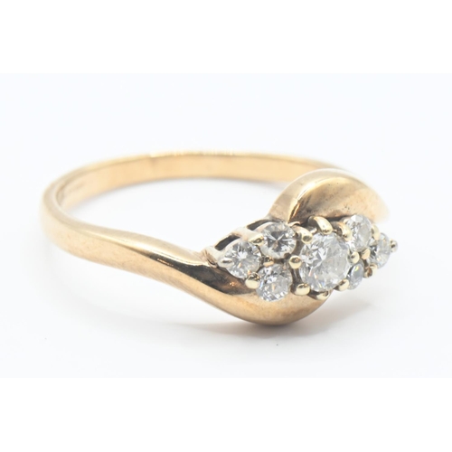 104 - 9ct gold and diamond crossover ring. Seven round brilliant cut diamonds, central stone approx. 3mm d... 