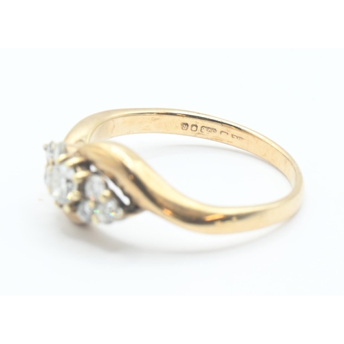 104 - 9ct gold and diamond crossover ring. Seven round brilliant cut diamonds, central stone approx. 3mm d... 