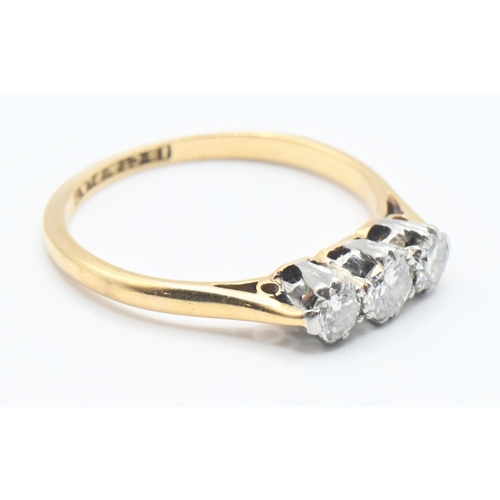 116 - 18ct gold and diamond trilogy ring featuring three brilliant cut diamonds mounted in platinum. Size ... 